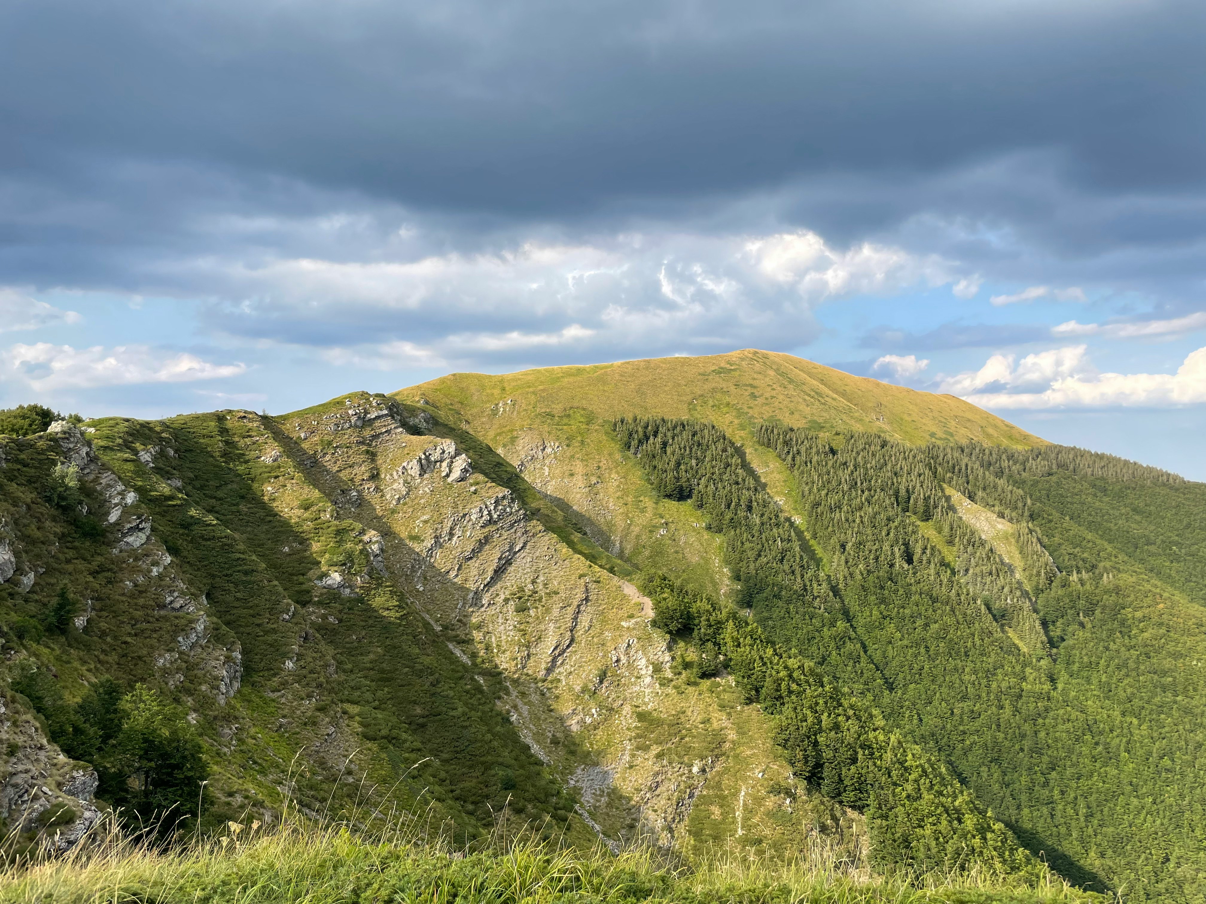 green and brown mountain under white clouds during daytime